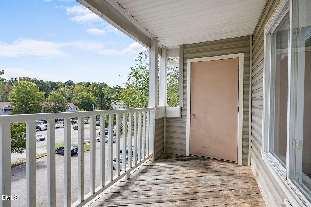 1411 Collegiate Circle, Unit 302 Raleigh, NC 27606 - Photo 36 of 43 a view of a balcony with wooden floor