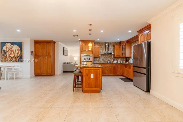 a kitchen with stainless steel appliances granite countertop a refrigerator sink and cabinets