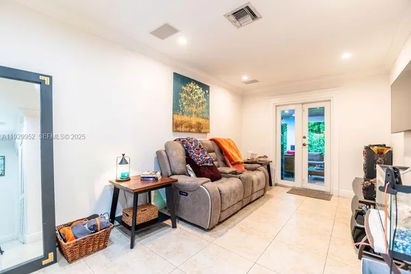 a living room with furniture and a flat screen tv