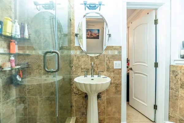 a bathroom with a sink a mirror and shower