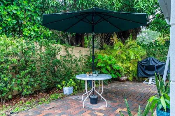 a view of a table and chairs under an umbrella