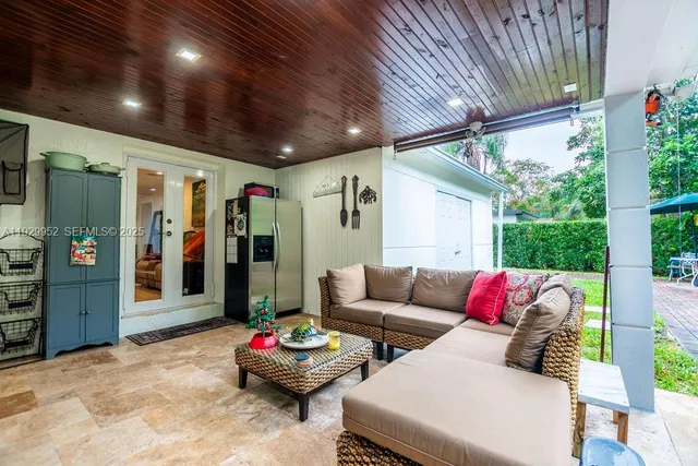 a living room with furniture and flowers