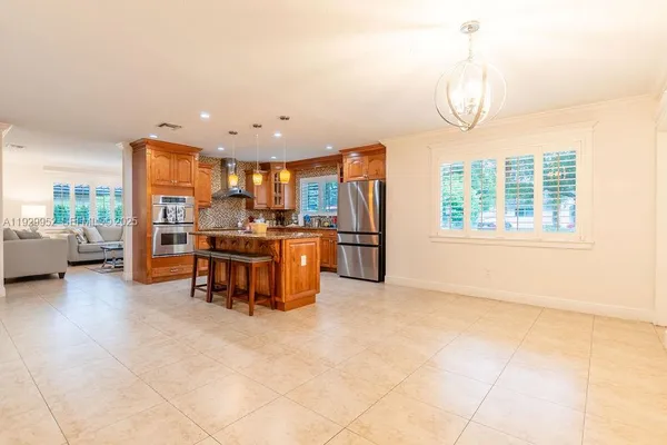 a view of kitchen with furniture and chandelier