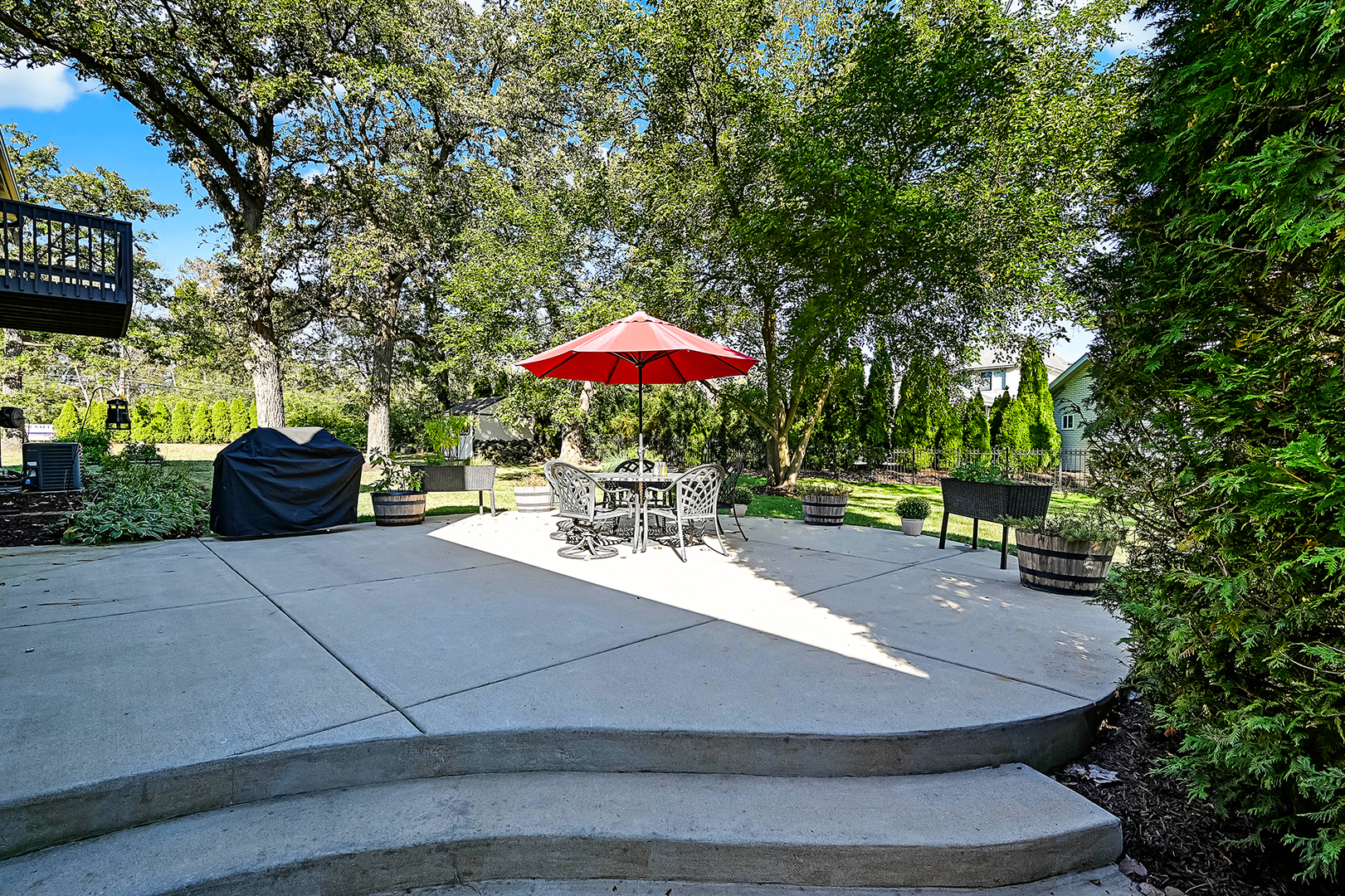 2 Carriage Lane Lemont, IL 60439 - Photo 35 of 44 a view of a patio with a table and chairs under an umbrella