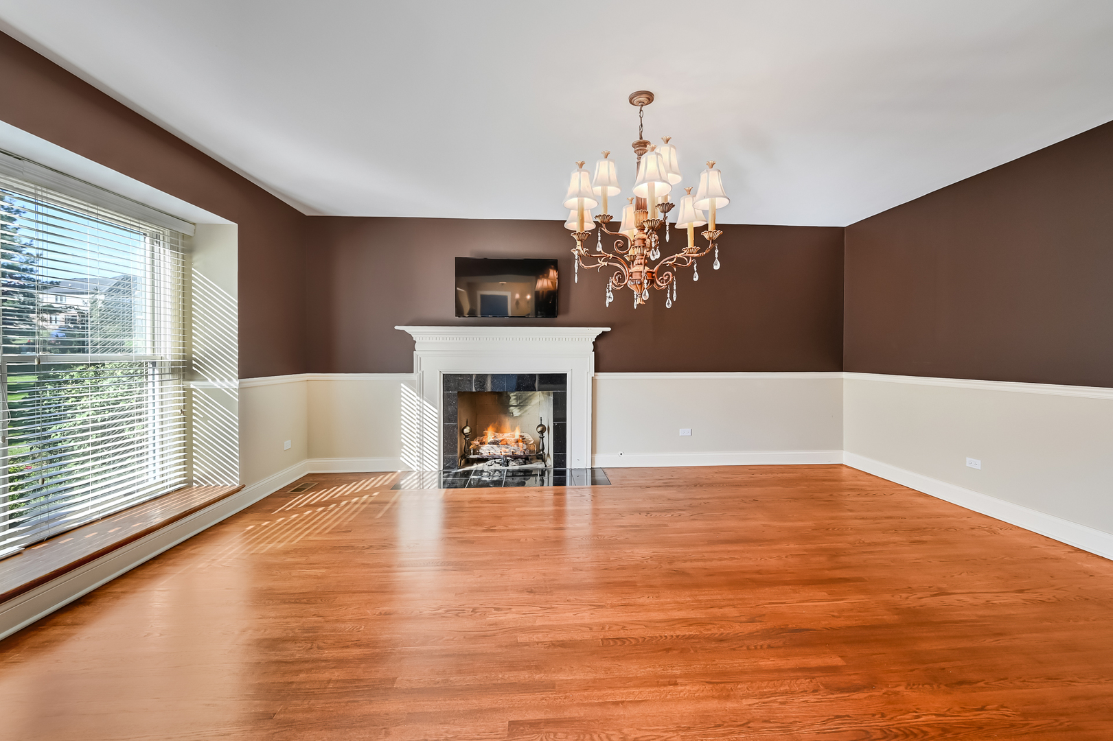 2 Carriage Lane Lemont, IL 60439 - Photo 6 of 44 a view of a livingroom with a fireplace wooden floor and chandelier
