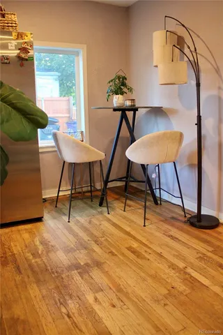 a view of a workspace room with furniture and wooden floor