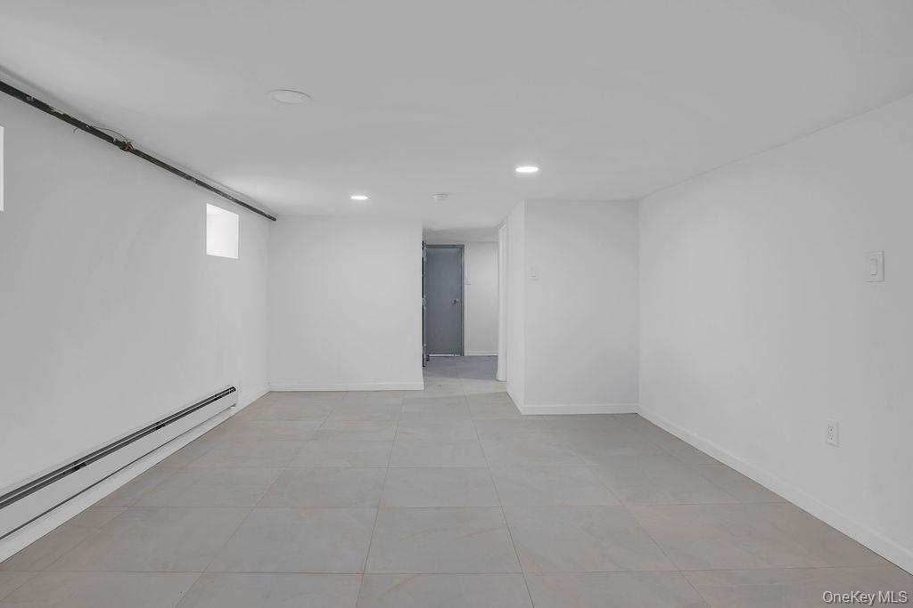 173-62 103rd Road Queens, NY 11433 - Photo 12 of 23 a view of an empty room with a window