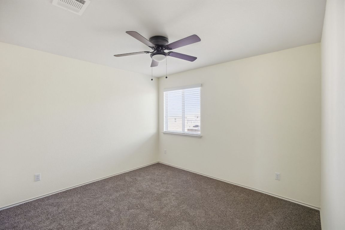 408 Azurite Drive Jarrell, TX 76537 - Photo 14 of 34 an empty room with a window and a fan