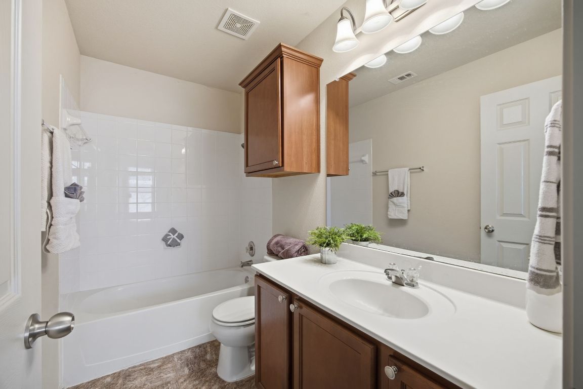408 Azurite Drive Jarrell, TX 76537 - Photo 17 of 34 a bathroom with a sink a toilet and shower