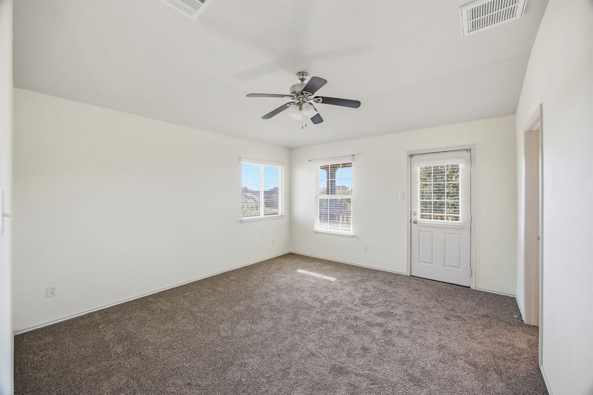 408 Azurite Drive Jarrell, TX 76537 - Photo 20 of 34 an empty room with windows and fan