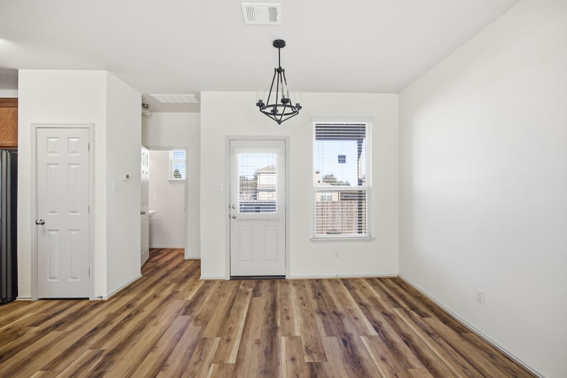 408 Azurite Drive Jarrell, TX 76537 - Photo 7 of 34 a view of a room with wooden floor and windows