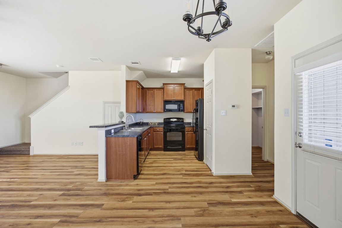 408 Azurite Drive Jarrell, TX 76537 - Photo 8 of 34 a kitchen with a refrigerator and a sink