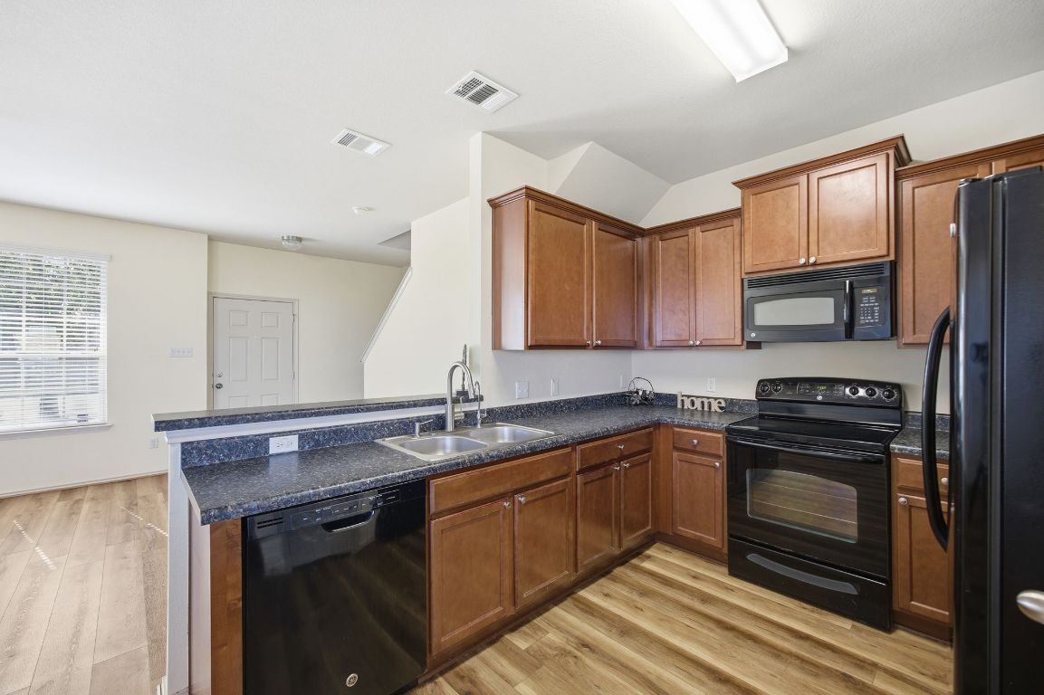408 Azurite Drive Jarrell, TX 76537 - Photo 10 of 34 a kitchen with stainless steel appliances granite countertop a sink stove and refrigerator