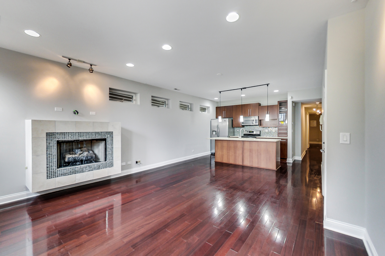 1231 East 46th Street, Unit GE Chicago, IL 60653 - Photo 4 of 16 a open kitchen with kitchen island a refrigerator stove and oven