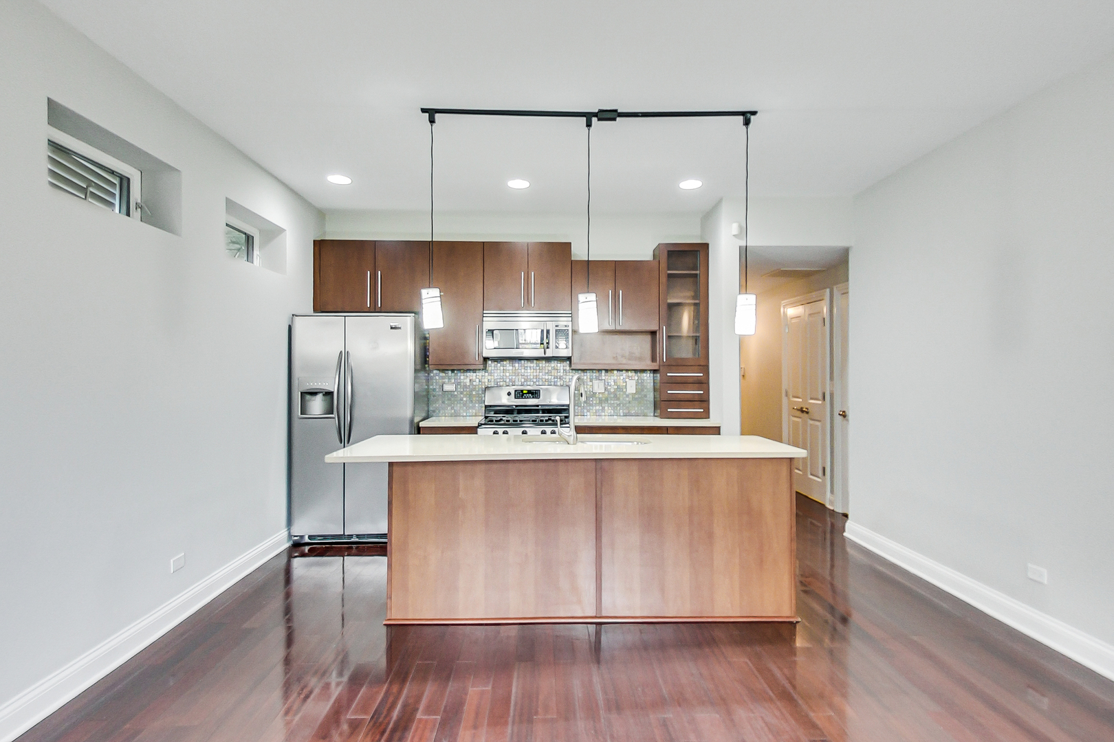 1231 East 46th Street, Unit GE Chicago, IL 60653 - Photo 5 of 16 a view of kitchen with stainless steel appliances refrigerator stove microwave and cabinets
