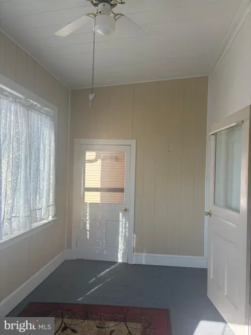 a white toilet sitting next to a shower
