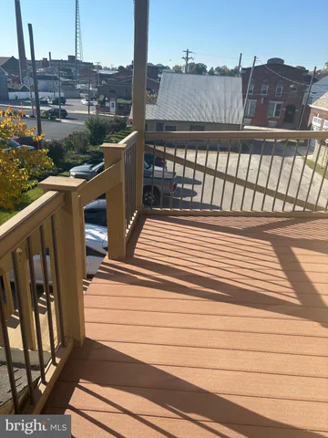 a view of a balcony with wooden floor