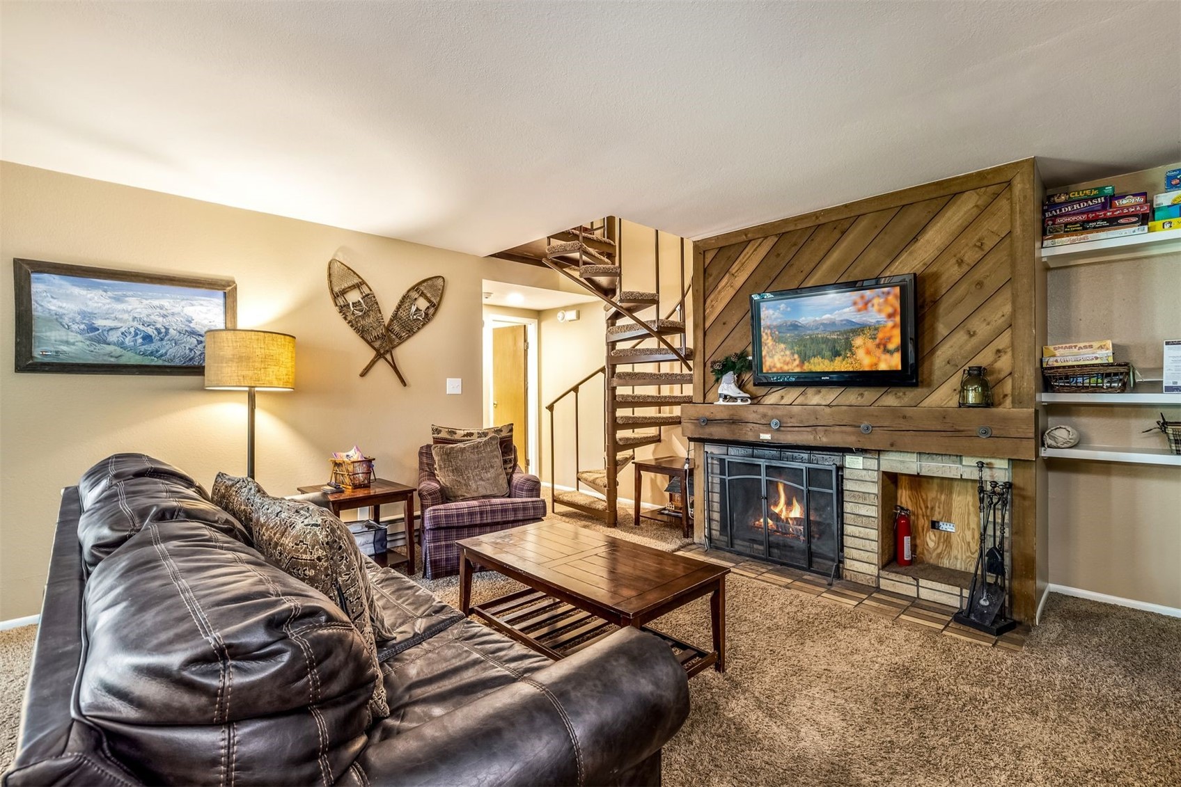 1977 Soda Ridge Road, Unit 1194 Keystone, CO 80435 - Photo 1 of 38 a living room with furniture gym equipment and a fireplace