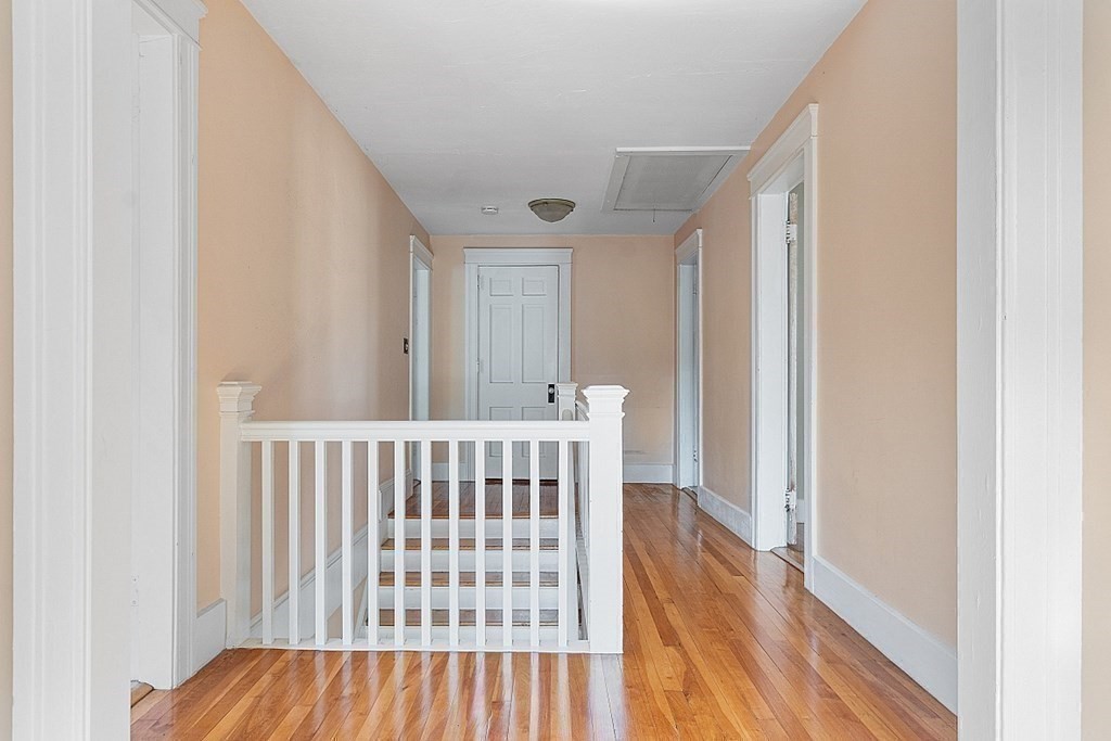 27 Woodman Road Worcester, MA 01602 - Photo 13 of 27 a view of a hallway with wooden floor and staircase