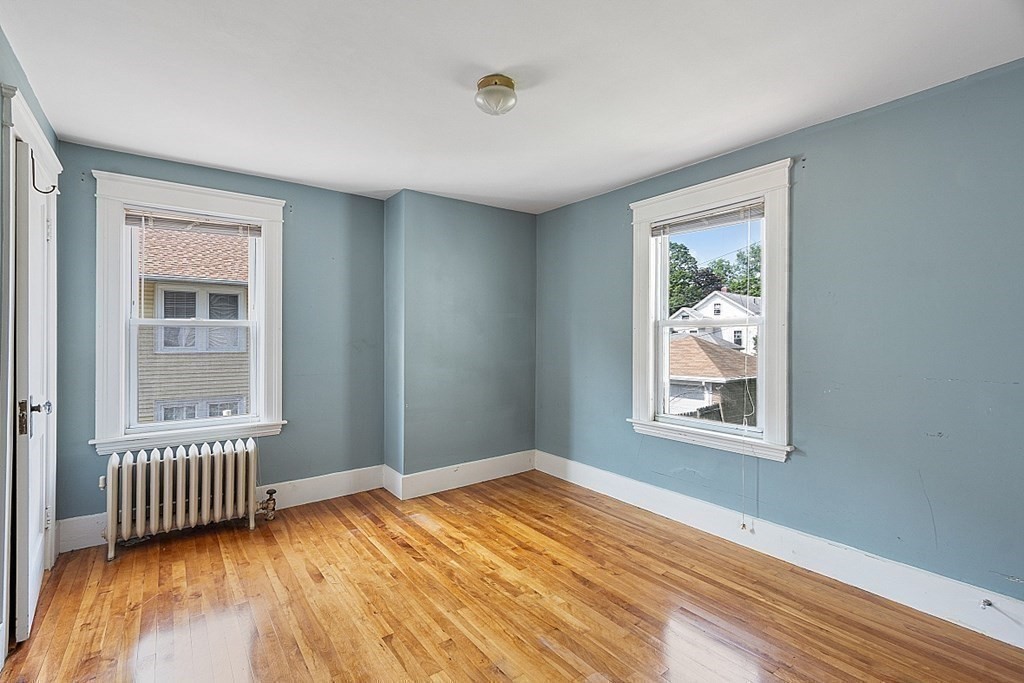 27 Woodman Road Worcester, MA 01602 - Photo 15 of 27 an empty room with wooden floor and windows