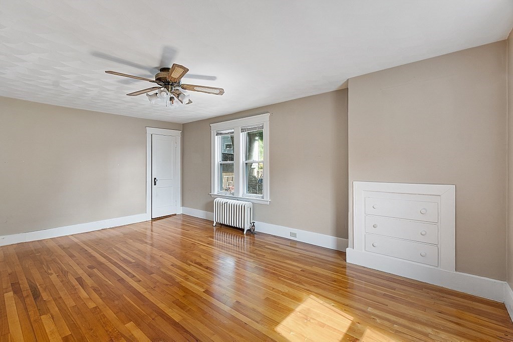 27 Woodman Road Worcester, MA 01602 - Photo 16 of 27 a view of empty room with wooden floor and fan