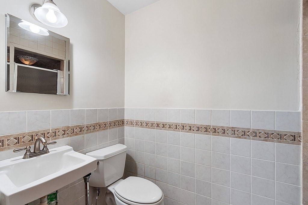 27 Woodman Road Worcester, MA 01602 - Photo 19 of 27 a bathroom with a sink mirror and toilet