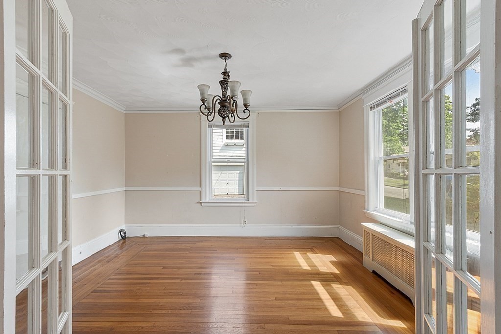 27 Woodman Road Worcester, MA 01602 - Photo 5 of 27 a big room with wooden floor a chandelier and windows