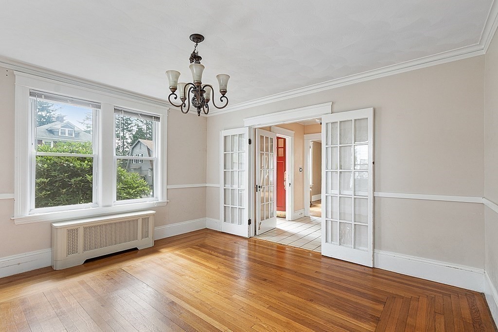 27 Woodman Road Worcester, MA 01602 - Photo 6 of 27 a view of an empty room with wooden floor and a window
