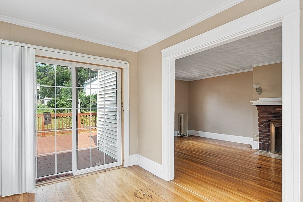 27 Woodman Road Worcester, MA 01602 - Photo 9 of 27 a view of empty room with wooden floor and fireplace
