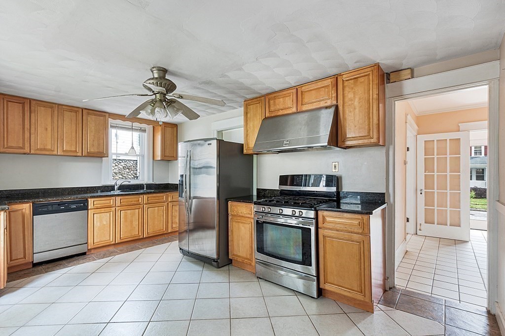 27 Woodman Road Worcester, MA 01602 - Photo 10 of 27 a kitchen with granite countertop a stove top oven cabinets and stainless steel appliances