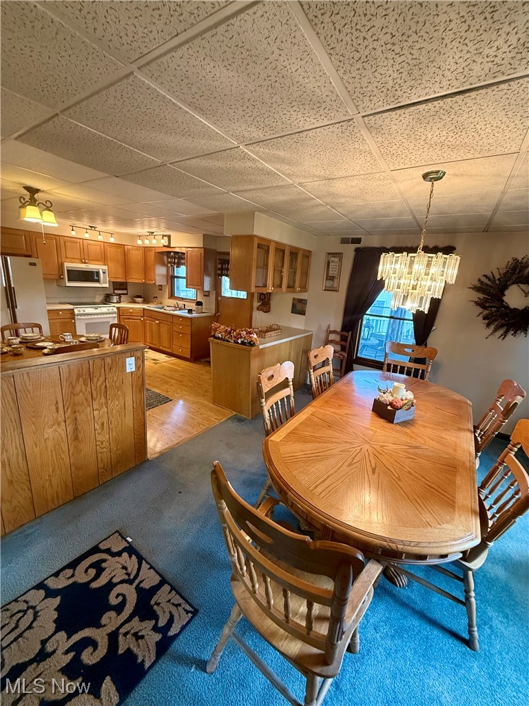 2614 Eldersville Road Follansbee, WV 26037 - Photo 8 of 18 Dining space with a paneled ceiling, a chandelier, and light carpet