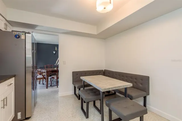 a kitchen with stainless steel appliances granite countertop a sink and dishwasher a refrigerator with white cabinets