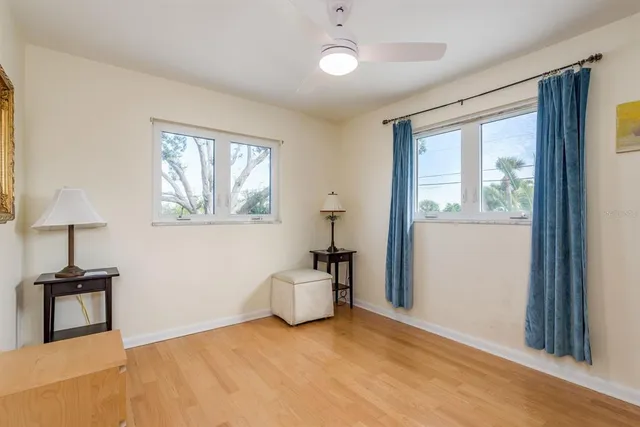 a view of an empty room with closet and a window