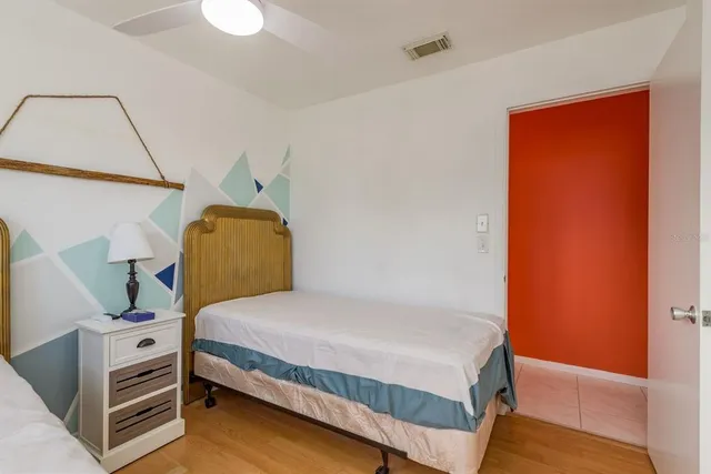 a view of a bedroom with furniture and window