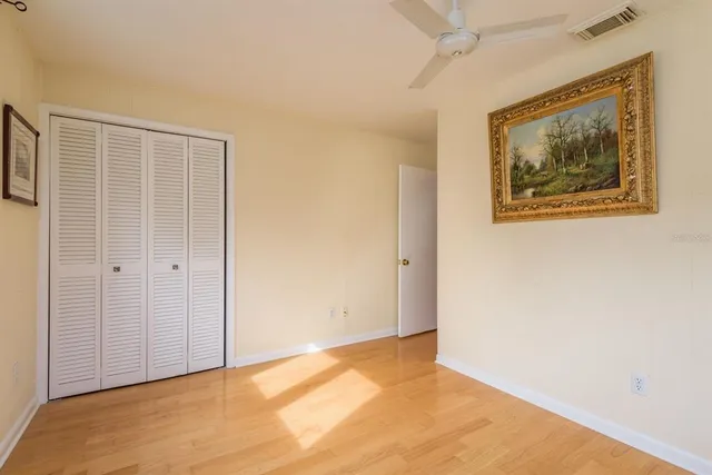 a living room with a floor to ceiling window and pool in a yard