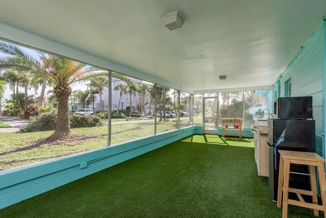 a living room with furniture pool table and a large window