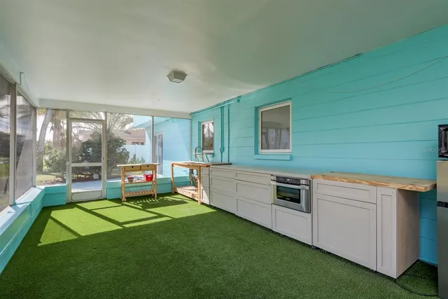 a kitchen with sink cabinets and stove top oven