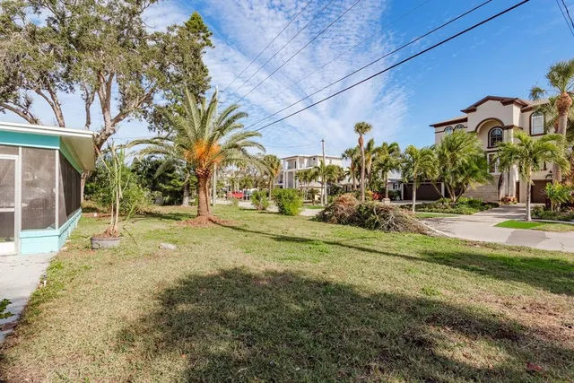 a view of a house with a yard and porch