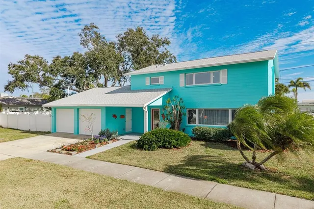 an aerial view of a house with a yard and lake view