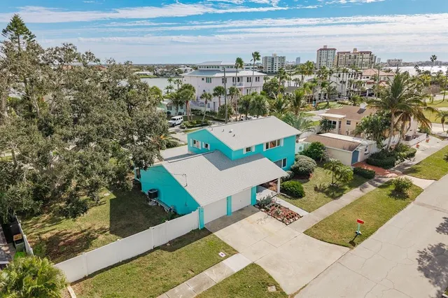 an aerial view of ocean with residential houses with outdoor space