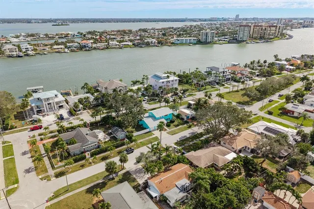 a front view of a house with a yard and potted plants