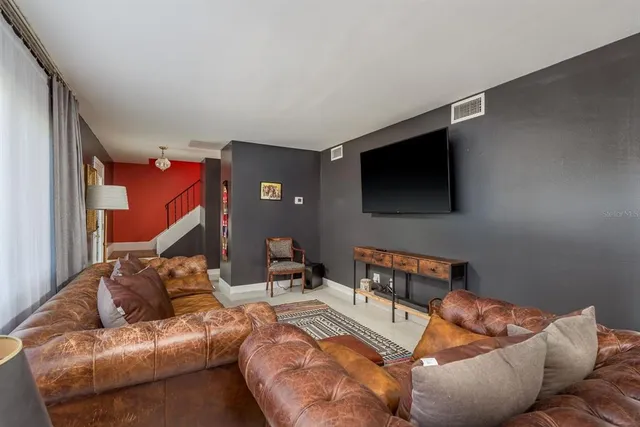 a view of a workspace with furniture and windows