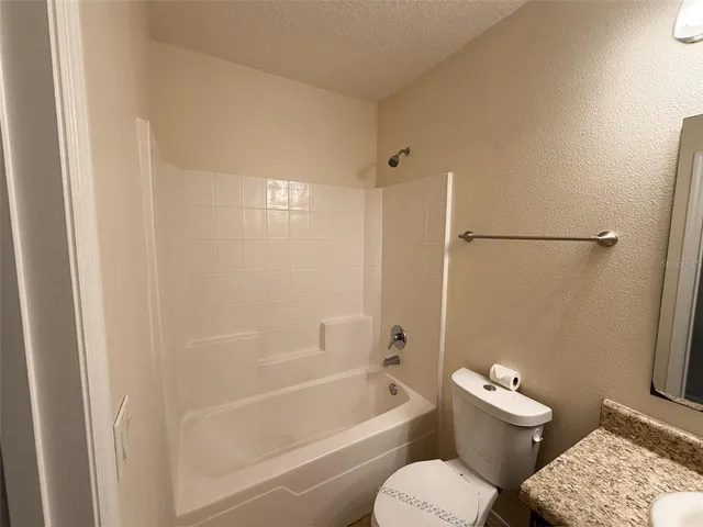 a bathroom with a toilet and a bathtub