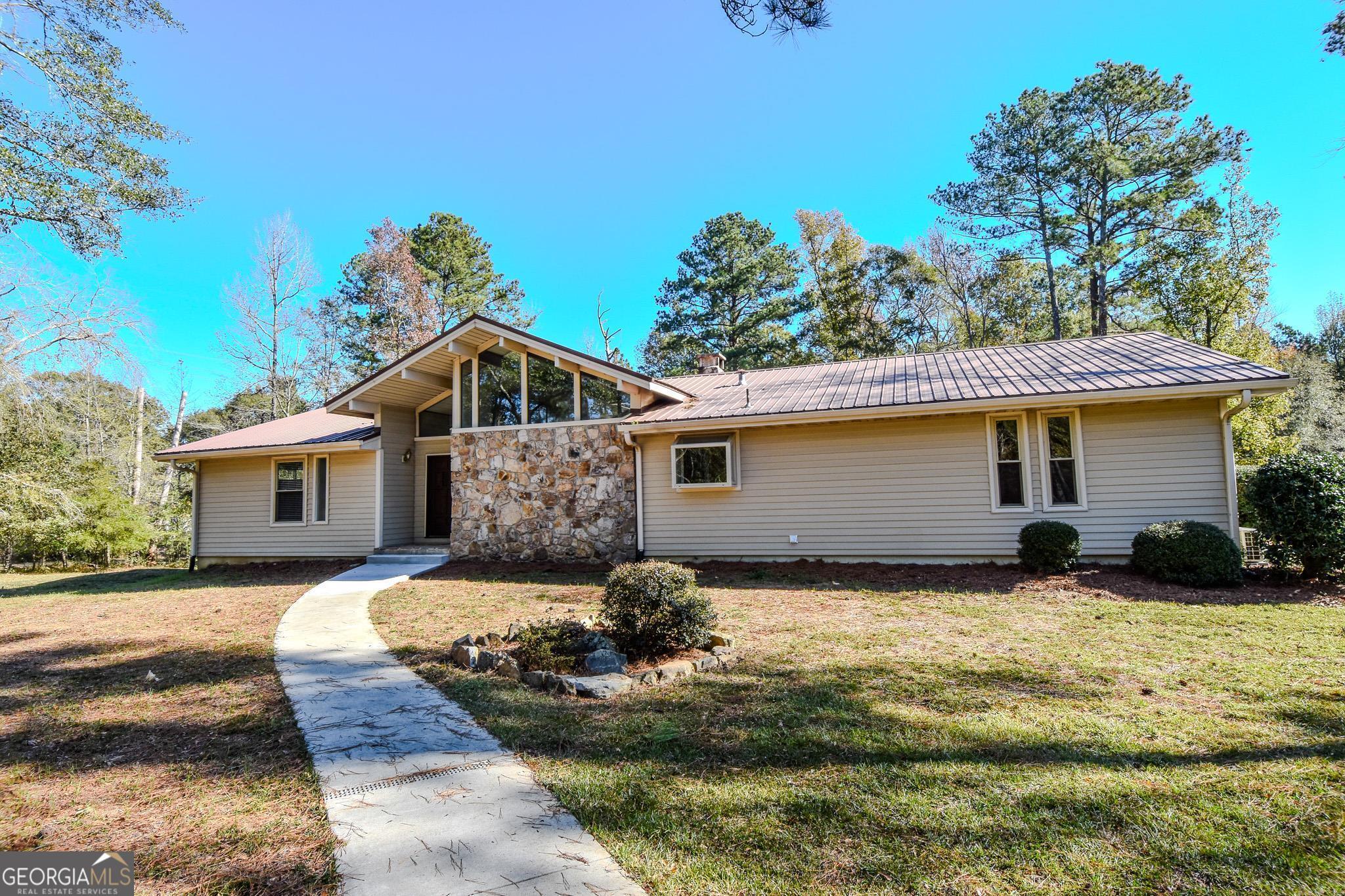 a front view of house with yard outdoor seating and barbeque oven