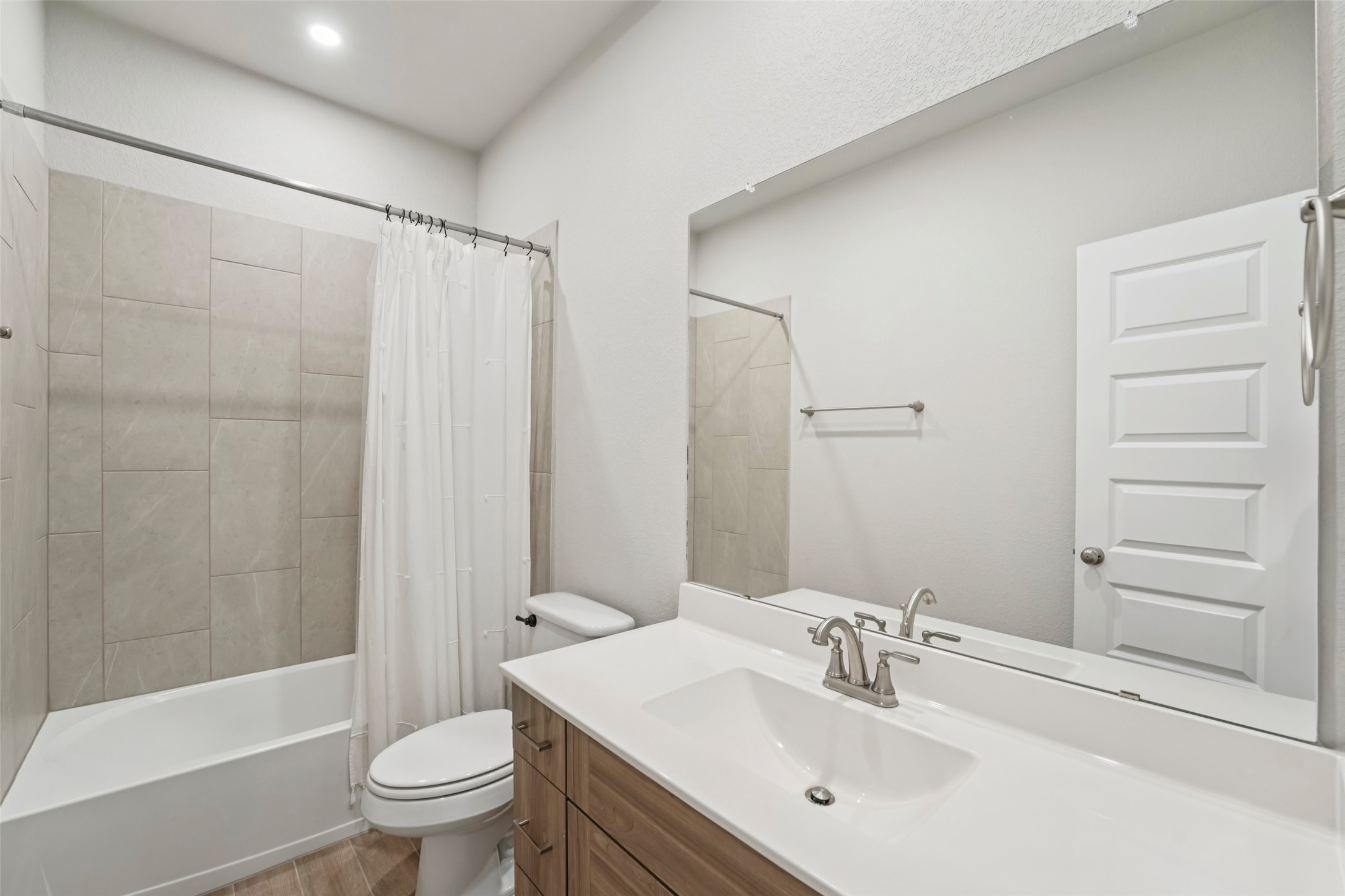 1108 Sweetspire Street Leander, TX 78641 - Photo 27 of 39 Full bath with vanity, shower / bath combo with shower curtain, and wood finished floors