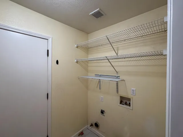 a view of storage and utility room with racks on the wall