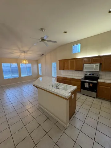 a kitchen with stainless steel appliances granite countertop a sink and a stove