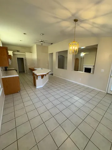 an open kitchen with furniture and chandelier