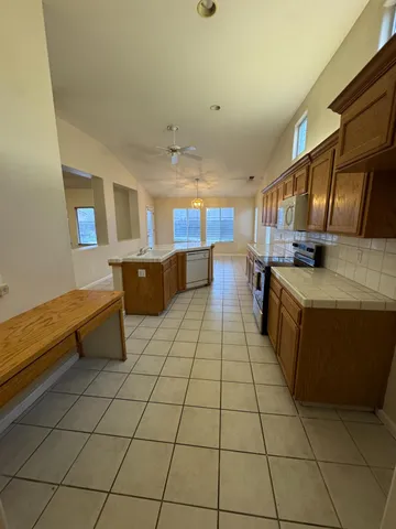 a kitchen with stainless steel appliances a stove a sink and a cabinets