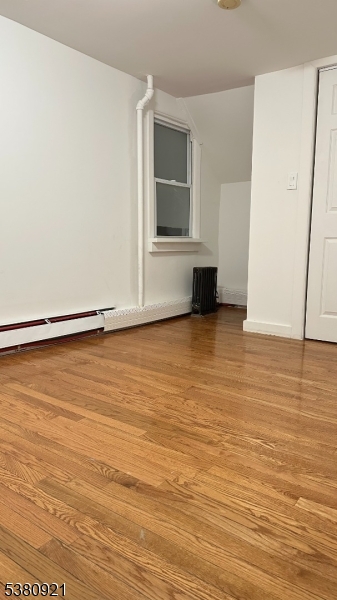 18 Irvine Turner Boulevard, Unit 2 Newark, NJ 07103 - Photo 2 of 11 an empty room with wooden floor and windows